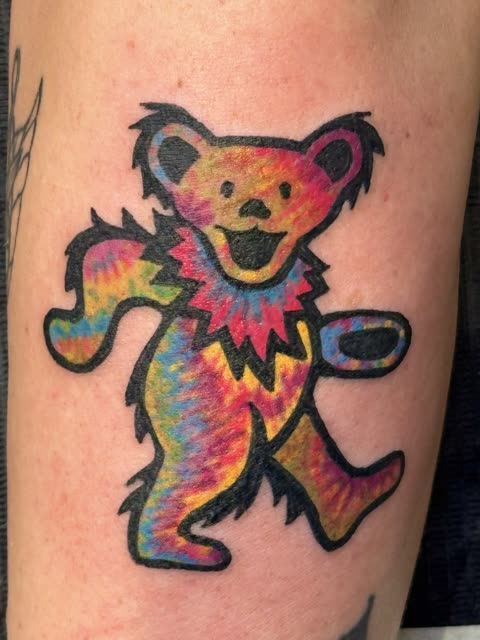 Tie-dye dancing bear tattoo in bright color