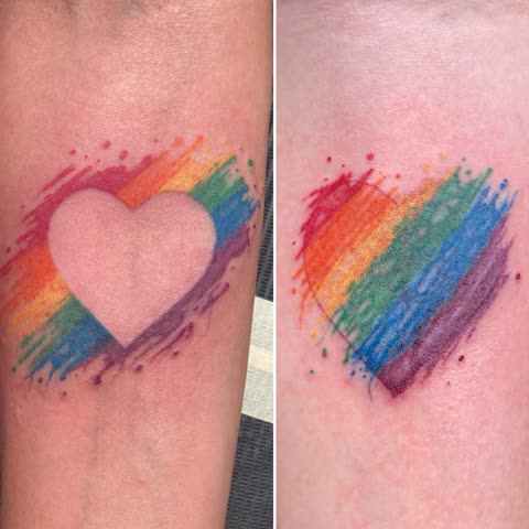 Matching rainbow heart tattoos in brushed watercolor on two forearms